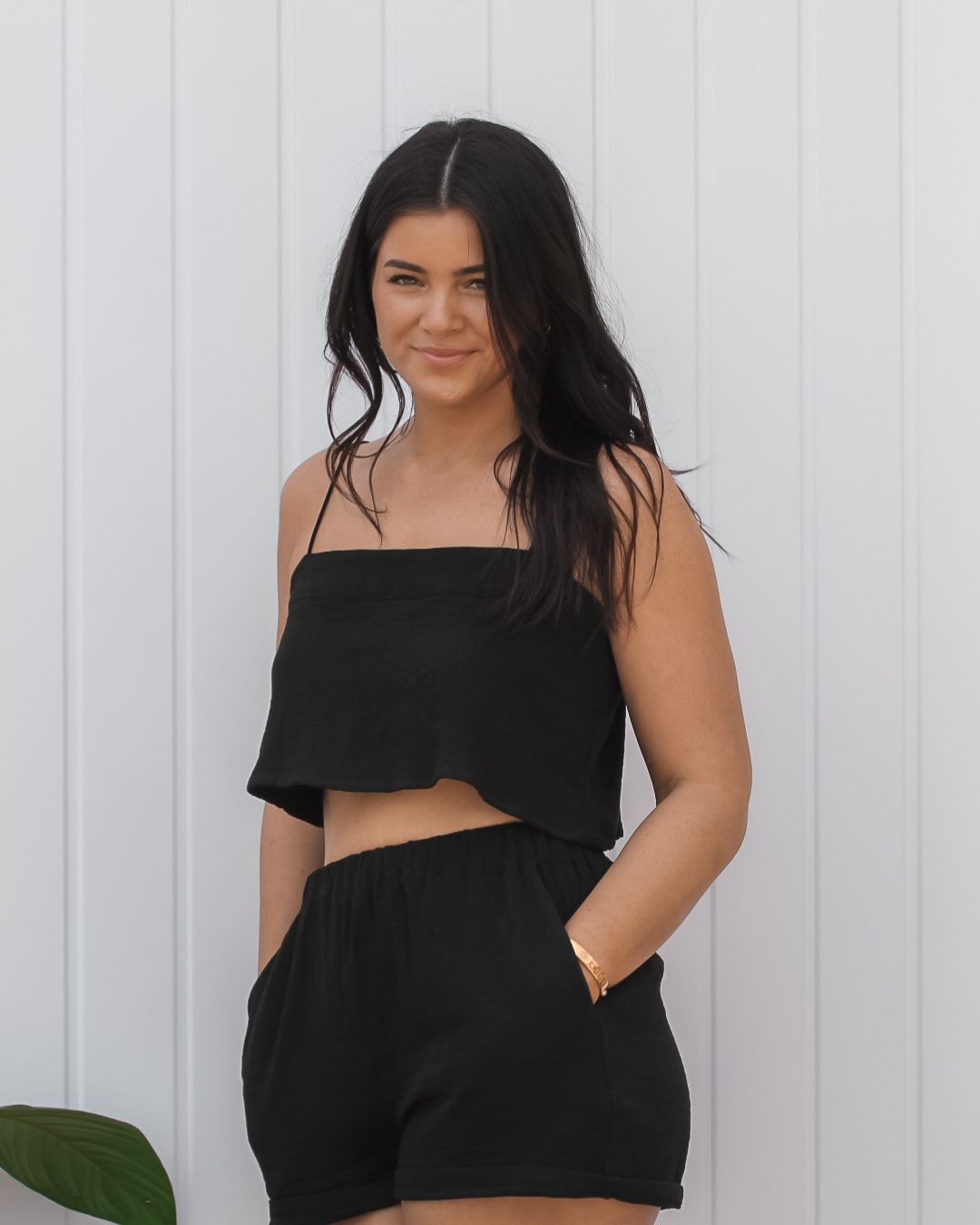 Black cotton crop top with spaghetti straps designed for resortwear and vacation outfits, breathable cotton travel clothing.