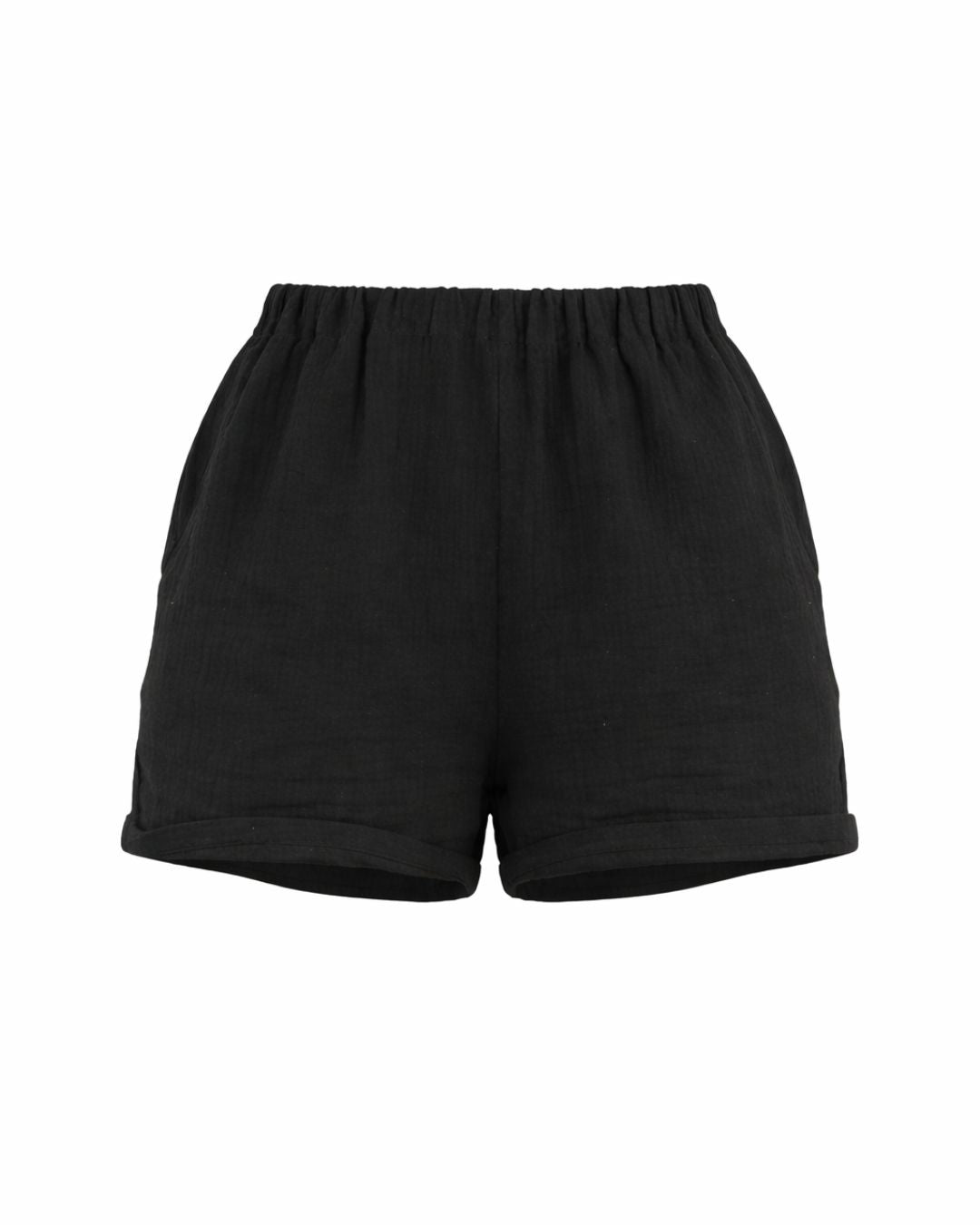 Black cotton resortwear shorts by Vaycaze, breathable lightweight vacation shorts styled for summer travel outfits.