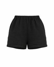 Black cotton resortwear shorts by Vaycaze, breathable lightweight vacation shorts styled for summer travel outfits.