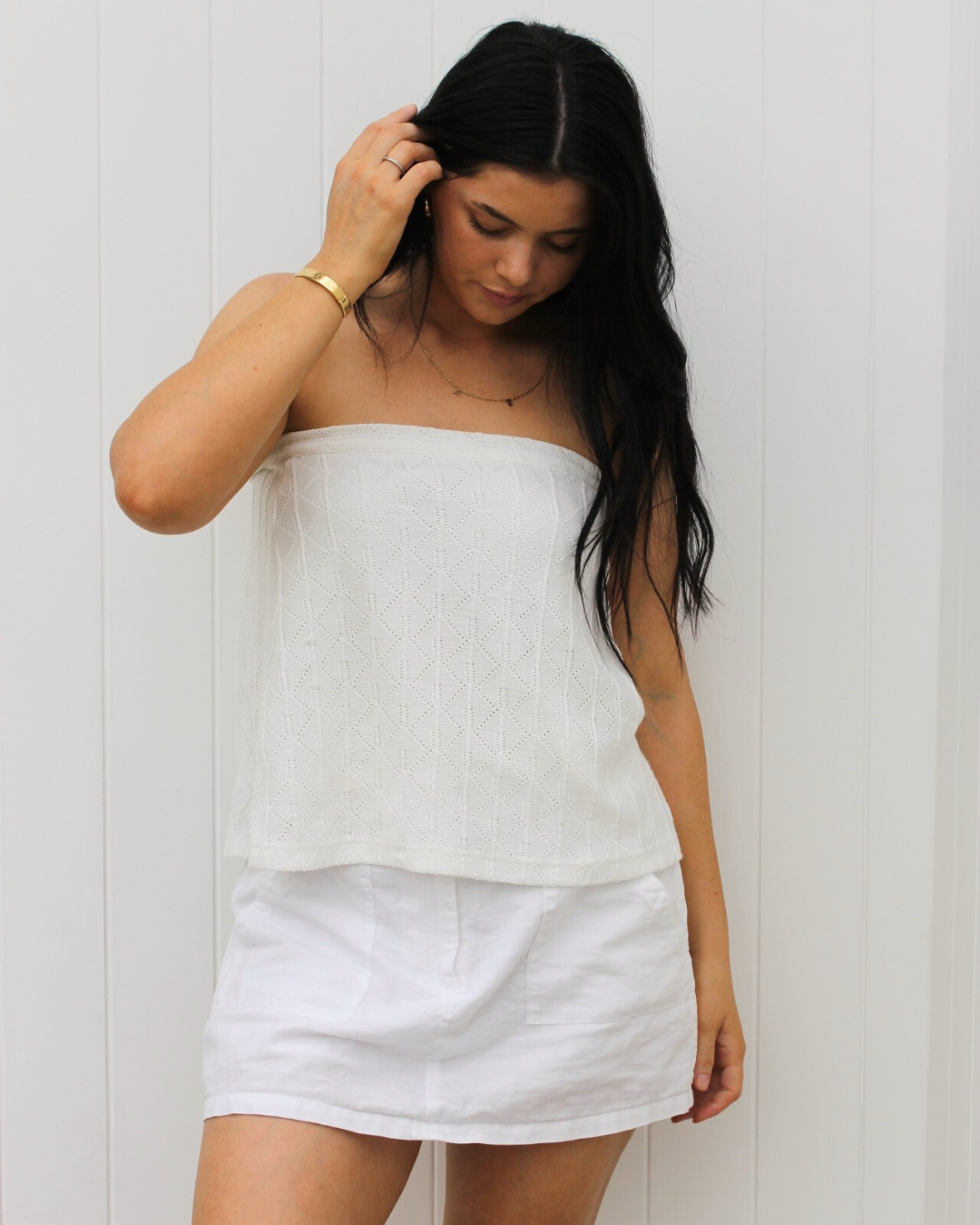 White Cove wrap skirt in white styled for resortwear, a lightweight and versatile travel skirt by Vaycaze.